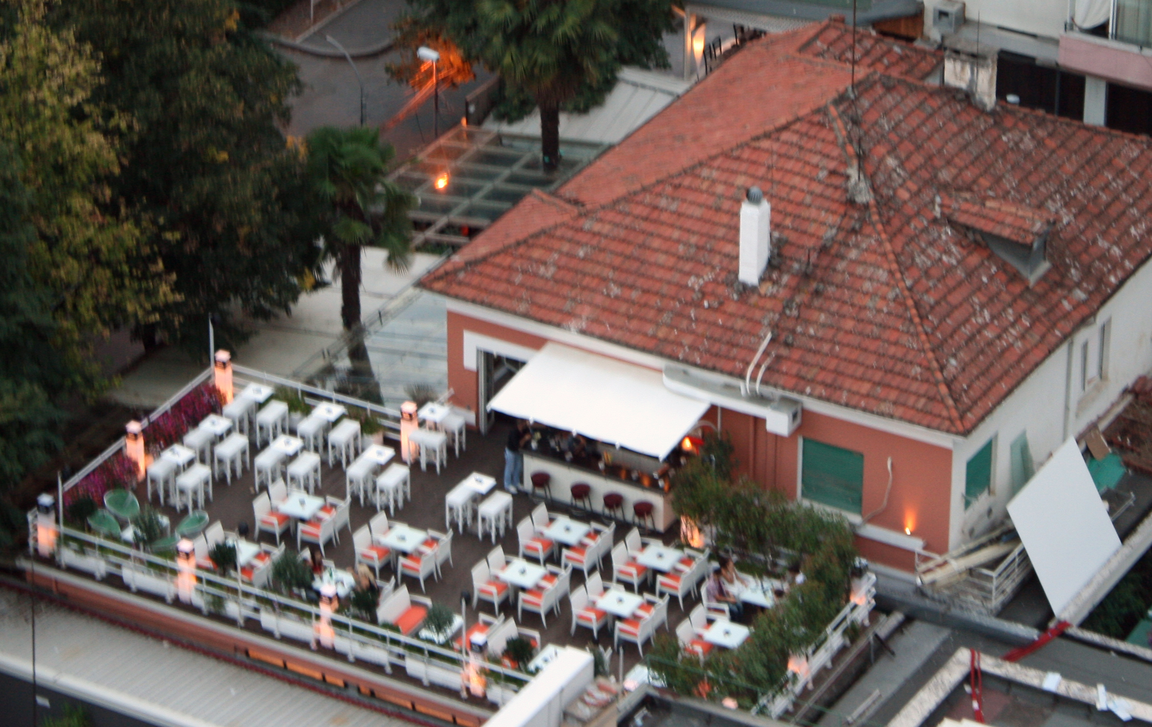 Empty restaurant at closing time with chairs stacked upside down on the tables